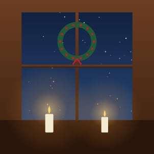 A snowy window with a wreath and candles
